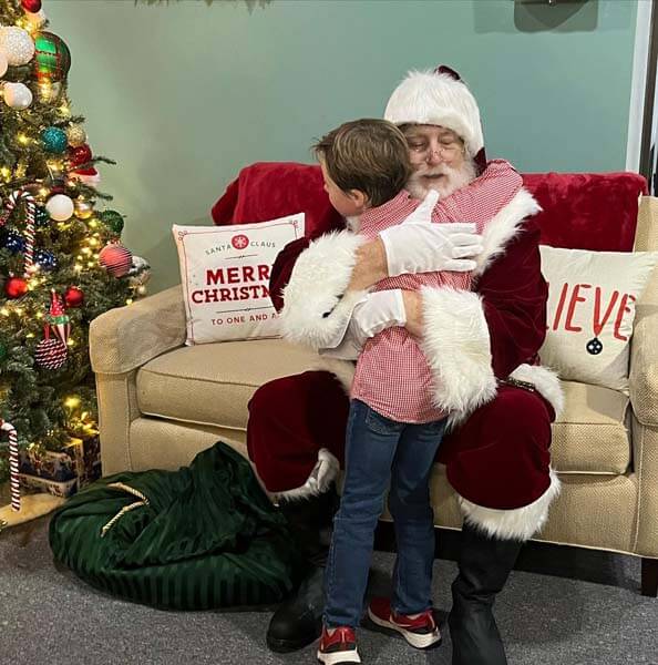 Santa hugging child