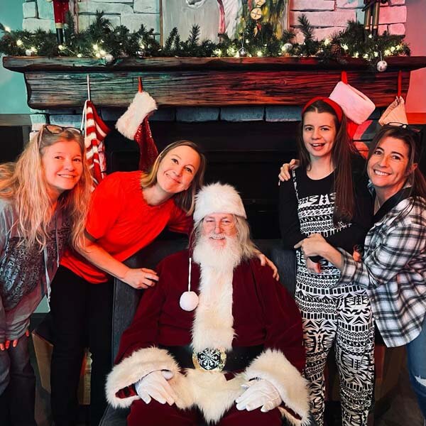 Family with Santa in front of fireplace