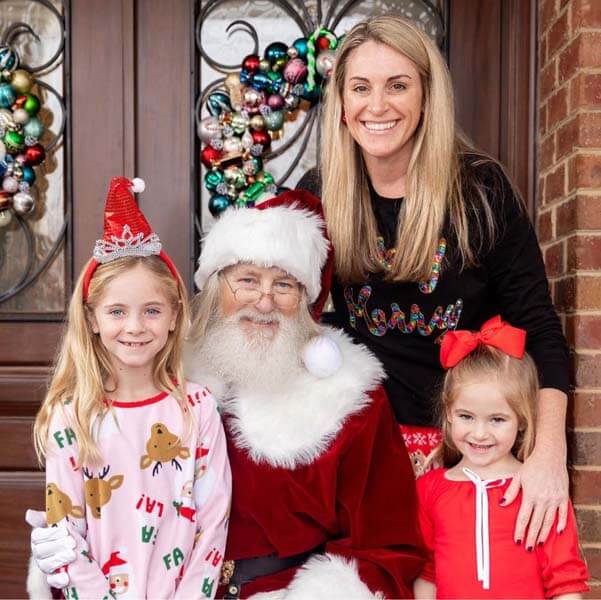 Family with Santa in front of door