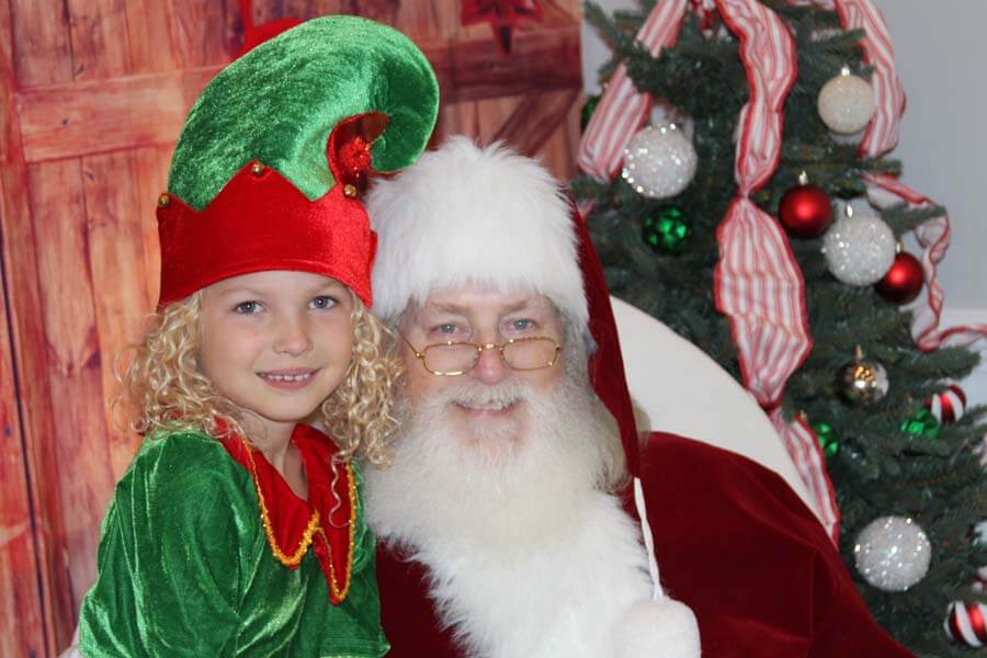 Santa with child dressed as elf
