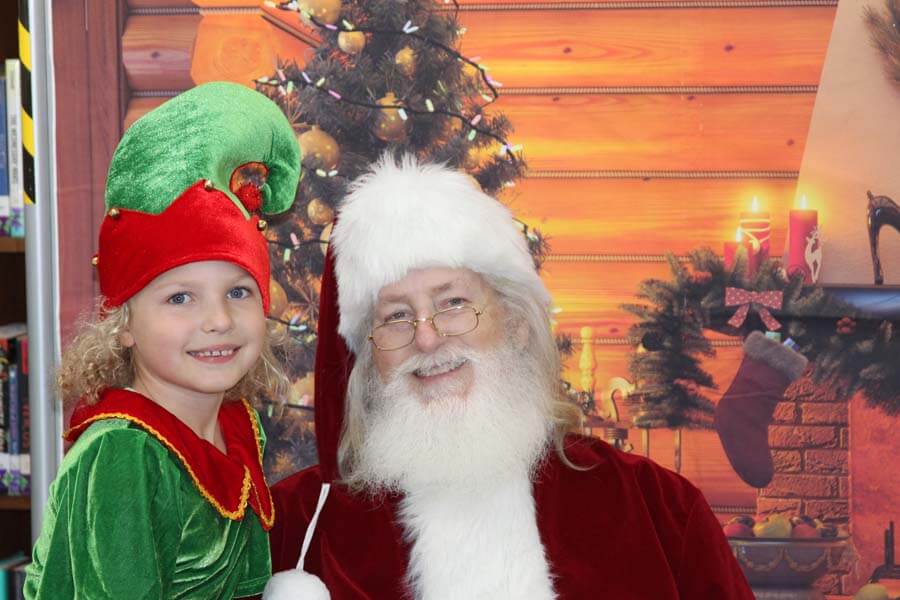 Santa with girl dressed as elf