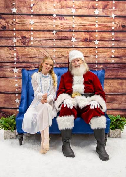 Girl in dress posing with Santa