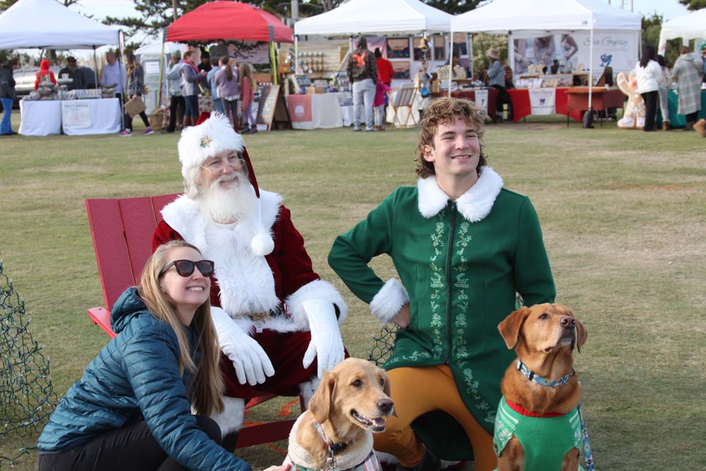 Santa and elf with woman and dogs